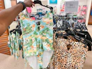 someone holding up a swimsuit in the swimwear section in jcpenney