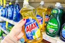 person grabbing an ajax dish soap off a shelf