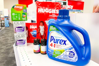 purex detergent, huggies diapers, olay moisturizer, zyrtec allergy medication, and cvs health vitamins on a shelf