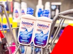 2 bottles of biotene mouthwash in a cart