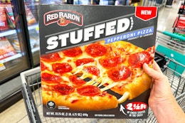 hand holding a red baron stuffed crust pizza