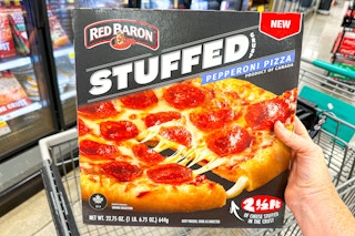 hand holding a red baron stuffed crust pizza