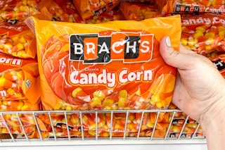 hand holding a brach's halloween candy corn bag