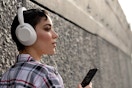 Woman wearing over-ear headphones.