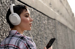 Woman wearing over-ear headphones.