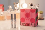 2 benefit cosmetic mascaras and a gift bag