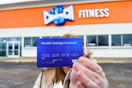 someone holding their hsa card outside of a Crunch fitness gym