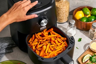 the Bella Pro Series Air Fryer, 3 qt on a kitchen counter filled with french fries