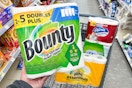 person holding a package of bounty paper towels over a cart