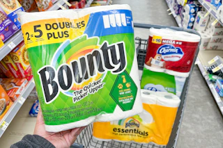 person holding a package of bounty paper towels over a cart