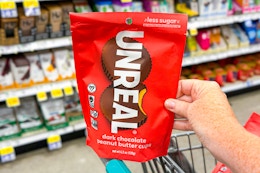 hand holding a bag of unreal chocolate peanut butter cups