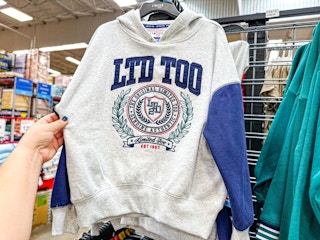 person grabbing a limited too sweatshirt