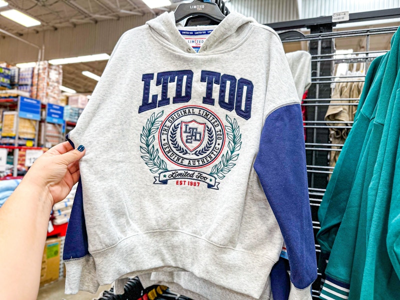 person grabbing a limited too sweatshirt