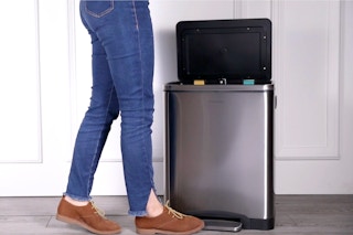Target double bucket trash can being used by a female