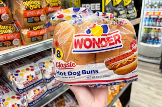 hand holding a package of wonder hot dog buns