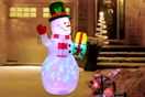 Lifestyle image of the Belita Amu Snowman Christmas Inflatable set up outdoors in front of a house