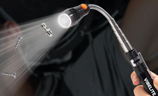 a magnetic flashlight picking up screws