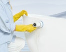 a person using an electric scrubber on a bathtub 