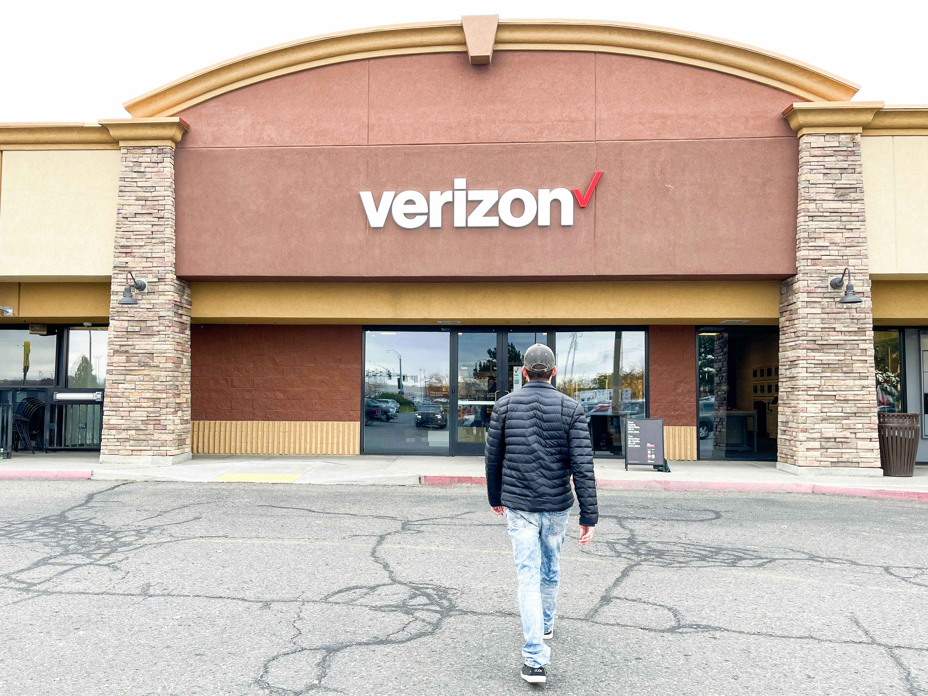 a person walking into a Verizon store