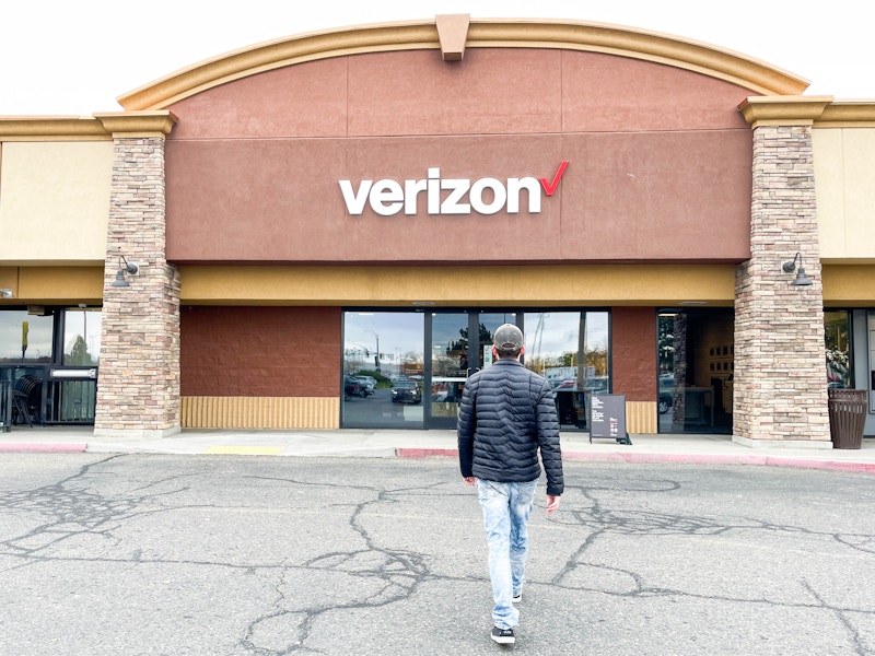 a person walking into a Verizon store