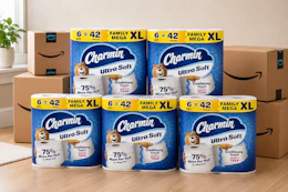 packs of toilet paper in front of Amazon boxes