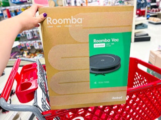 roomba robot vacuum sitting on top of a target cart