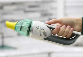 Some holding a Horsepower Duck Portable Vacuum.