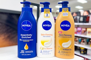 three bottles of nivea body lotion on a shelf in a store