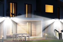 A home with 2 solar outdoor lights illuminating the area outside the first floor