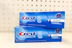 crest pro-health toothpaste stacked on store shelf