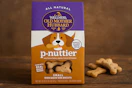 a hand holding a bag of dog treats