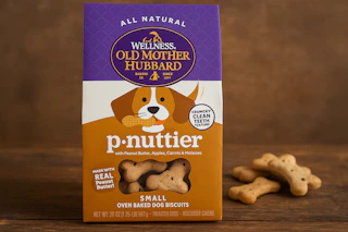 a hand holding a bag of dog treats