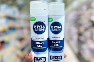 hand holding two cans of nivea shave gel