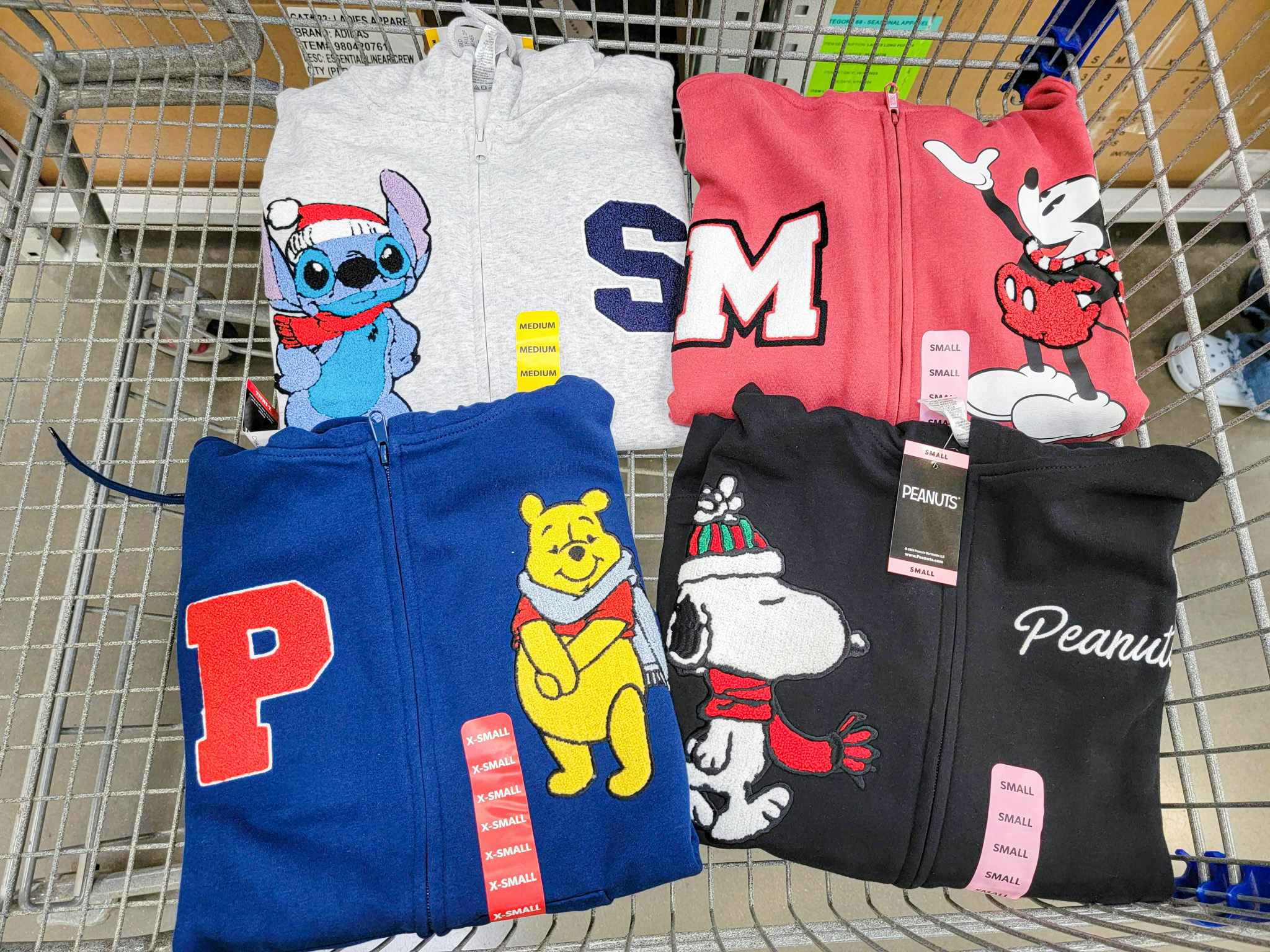 stitch, mickey, pooh, and peanuts hoodies in a cart