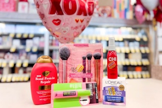 ogx shampoo, maybelline mascara, real techniques makeup brush set, chi heat spray, and loreal moisturizer on a shelf with a xoxo balloon