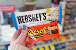 hand holding hershey reese's candy bars