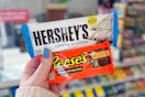 hand holding hershey reese's candy bars