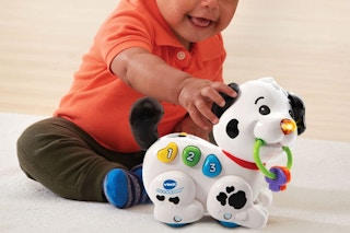 A child playing with the Vtech puppy toy