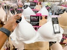 a bali bra held up in front of bras on hangers in the bra section of macys