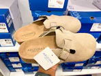 hand holding pair of clog shoes