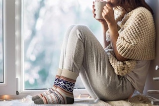 a woman sitting with winter socks on