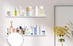 skincare bottles and jars on acrylic shelves on a wall