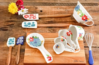 Lifesyle image of The Pioneer Woman Kitchen Gadget Set laid out on wooden table
