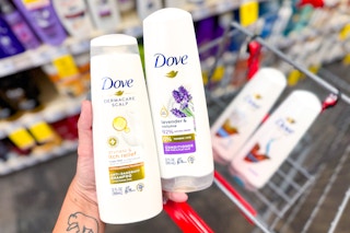 hand holding two bottles of Dove shampoo and conditioner