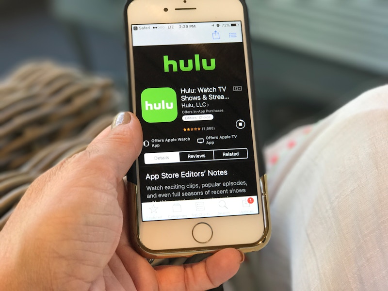 someone holding phone with hulu app