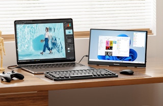 a laptop on a desk with a portable monitor