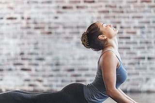 A woman wearing a hair clip while doing yoga