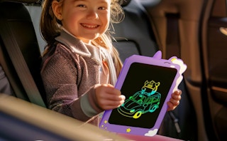a kid in a car holding a purple tablet