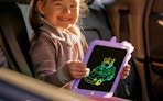 a kid in a car holding a purple tablet