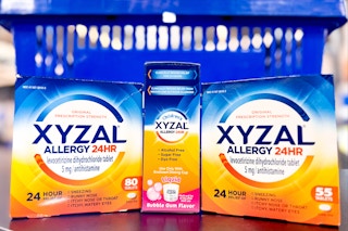 3 xyzal allergy sitting in front of a walmart basket